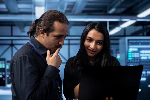 IT experts in server hub doing brainstorming finding ways to shield data