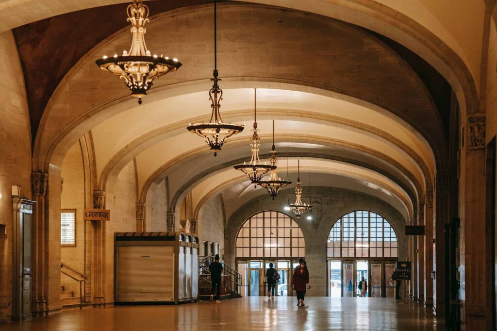 A long hallway with elegant chandeliers.
