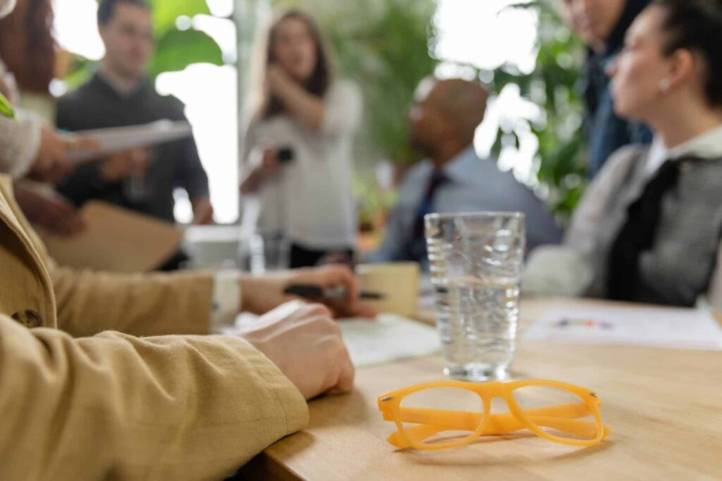A group of people sitting around a table discussing cybersecurity threats.