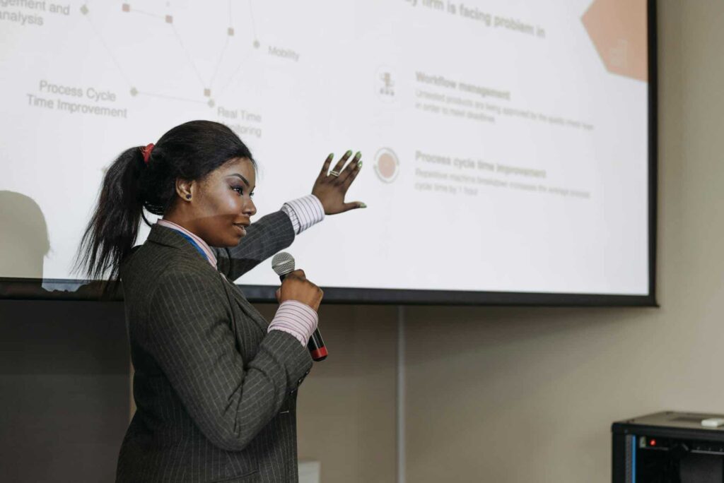 A woman presenting in front of a screen during an FTC safeguards rule session.